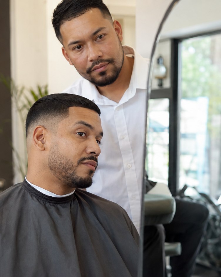 Finished taper check with an adult client and a male barber in a white shirt