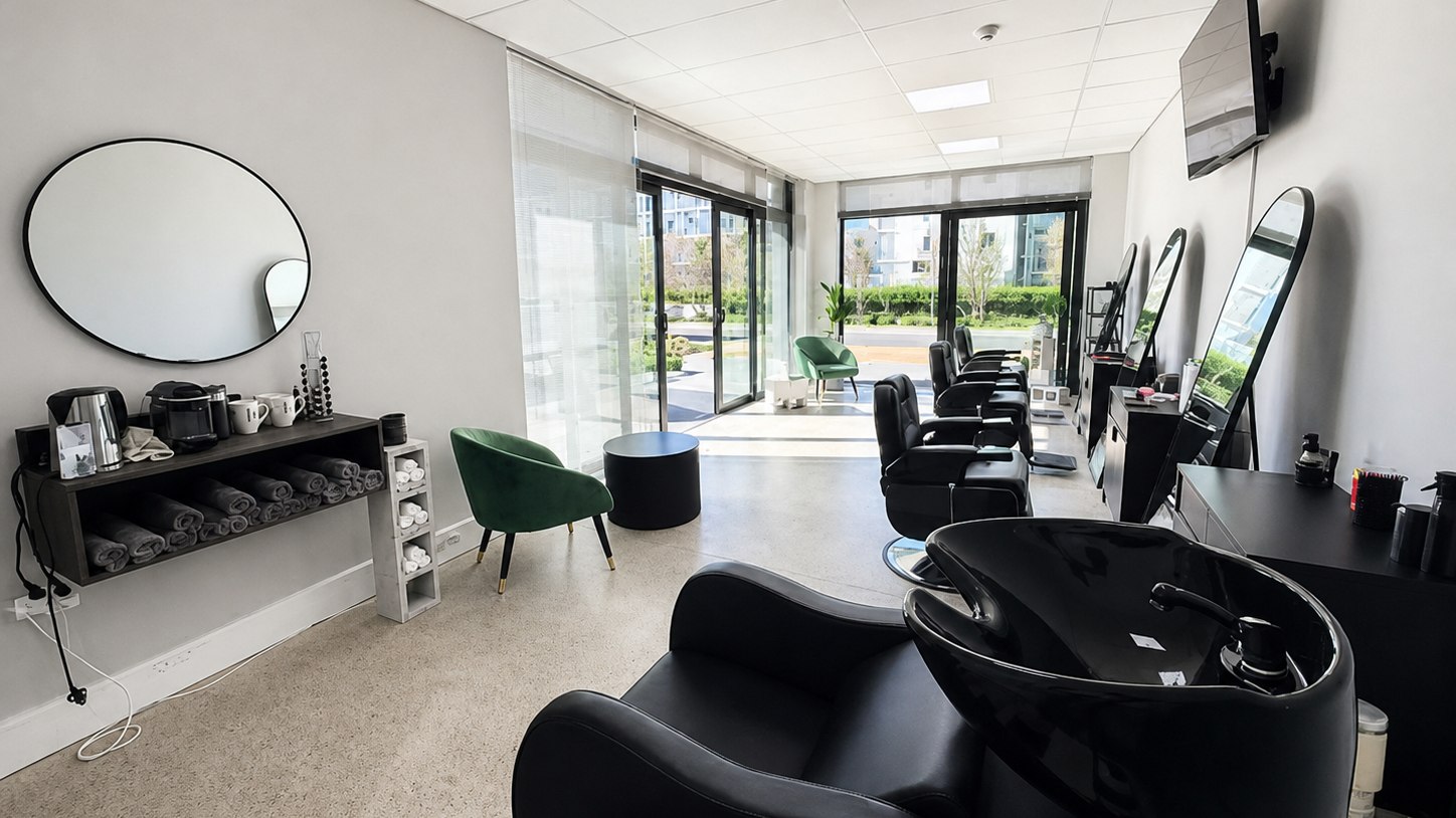 Bright Barber Blatt interior with black barber chairs and arched mirrors