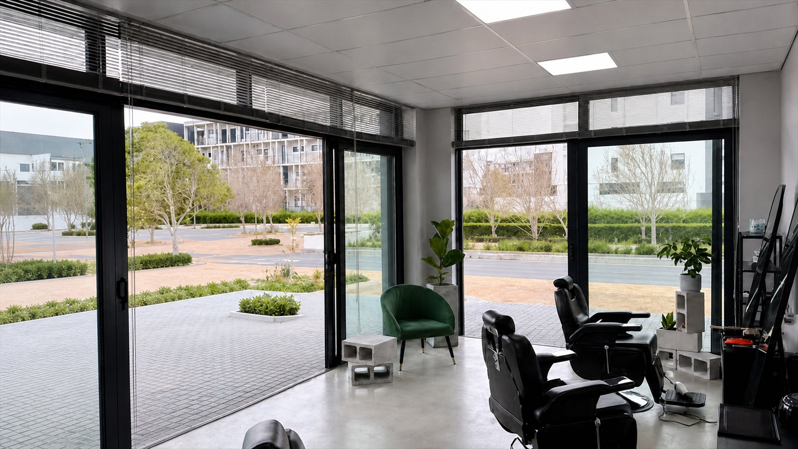 View from inside the shop toward the broad front glazing and green chair